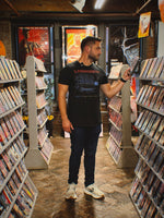 Watch Different Tee lifestyle photo browsing VHS tapes in a video store