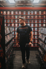 Watch Different Tee lifestyle photo walking through a retro video store aisle